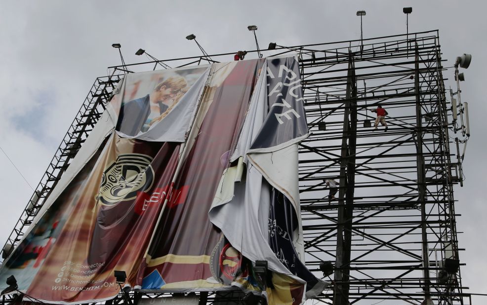Workers bring down a billboard in Makati, Philippines, on November 7 before Haiyan makes landfall.