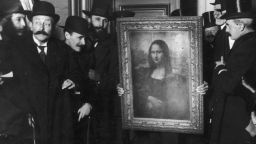 Officials gather around Leonardo da Vinci's 'Mona Lisa' (aka 'La Gioconda' or 'La Joconde') upon its return to Paris, 4th January 1914. It was stolen from the Musee du Louvre by Vincenzo Peruggia in 1911, and has only just been recovered. (Photo by Paul Thompson/FPG/Archive Photos/Getty Images)