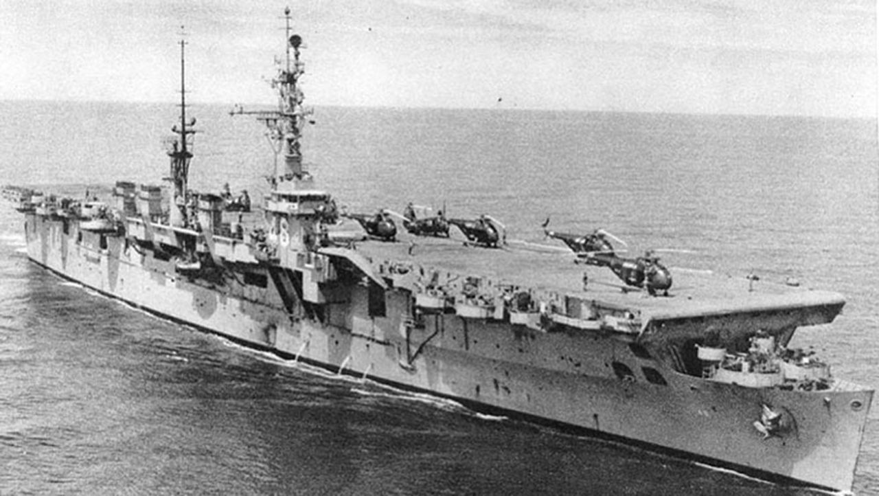 Helicopters sit on the flight deck of the USS Saipan during the mid-1950s. The ship was one of two members of the Saipan class.