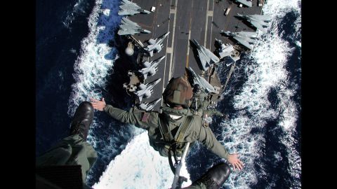 Aircrew members are lifted from the flight deck of the USS John F. Kennedy during an exercise in 2002. The ship, which was decommissioned in 2007, was the only member of its class.