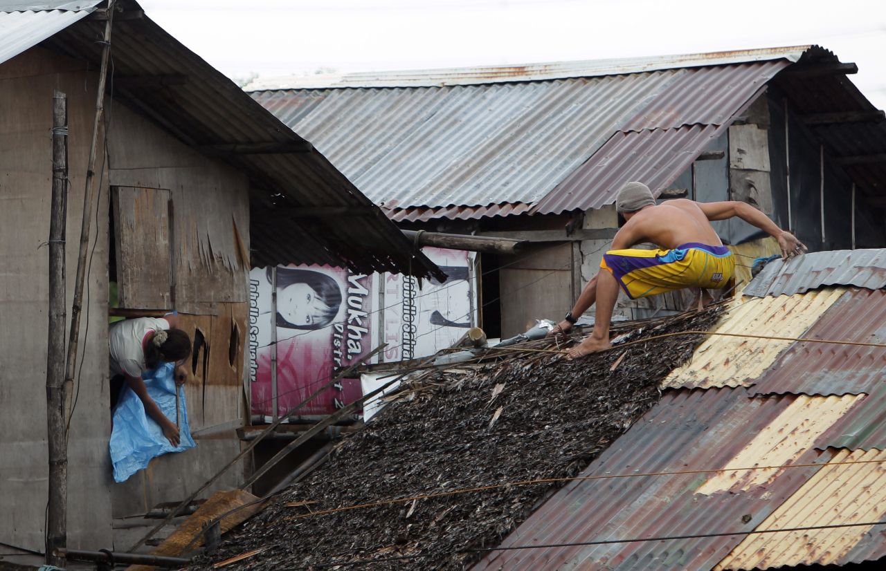 Residents reinforce their homes in Las Pinas on November 8.