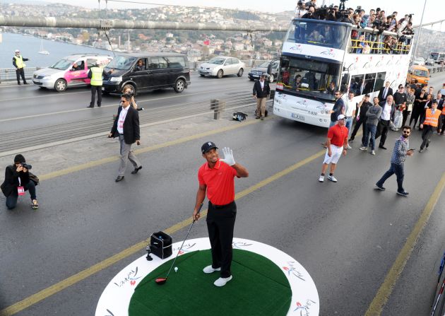 Wherever the world's most famous golfer goes, a troop of cameramen and journalists are bound to follow. If Woods was feeling under pressure ahead of his historic drive, he wasn't showing it.