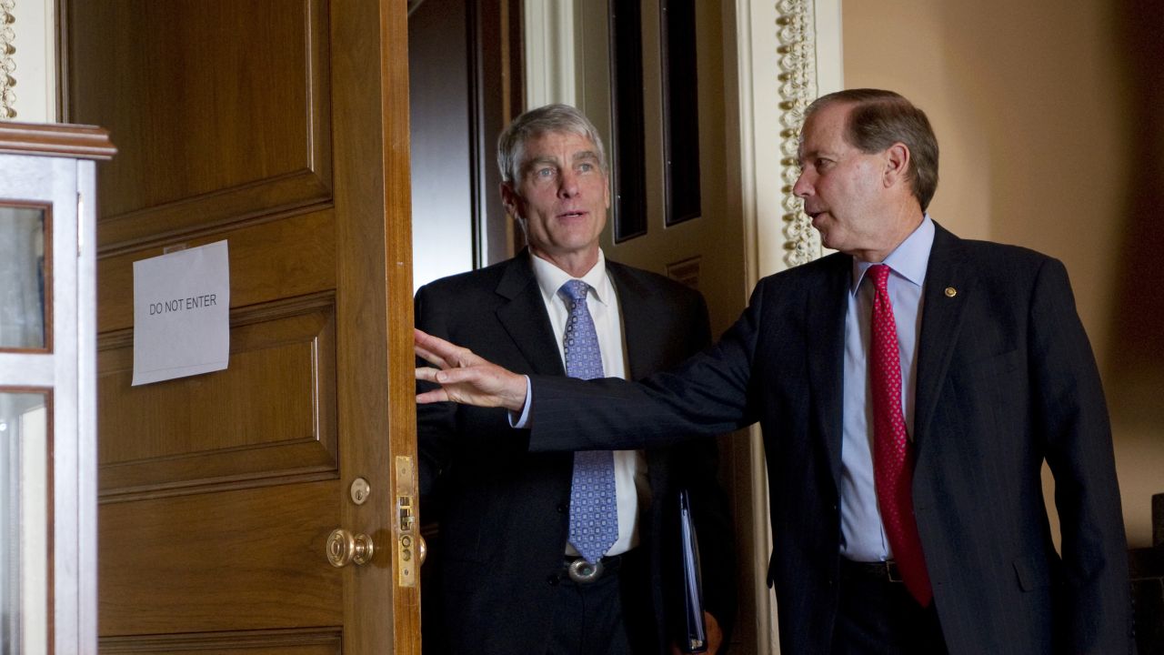 Sen. Mark Udall, D-Colorado, and his cousin Sen. Tom Udall, D-New Mexico, attend a weekly Senate policy luncheon in Washington in 2012.