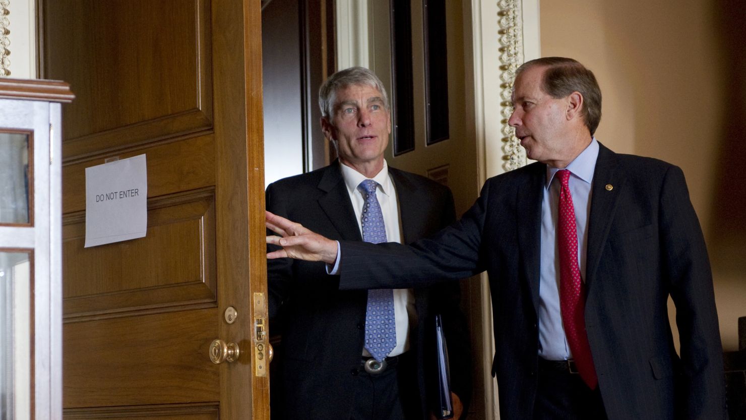 Sen. Mark Udall, D-Colo., and his cousin Sen. Tom Udall, D-N.M., attend a weekly Senate policy luncheon in Washington, D.C.