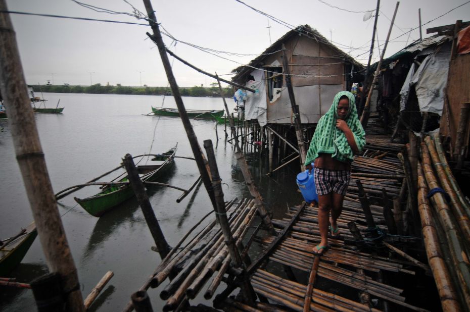 A resident walks along a fishing village in Bacoor, Philippines, on November 8.