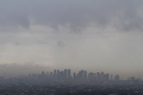 Dark clouds brought by Haiyan loom over Manila skyscrapers on November 8.