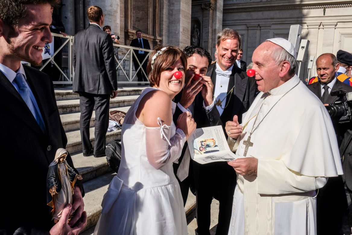 Pope Francis jokes with members of the Rainbow Association, which uses clown therapy in hospitals, nursing homes and orphanages. Many Catholics saw this image as the joyful flip side of Francis' embrace of the disfigured man. 