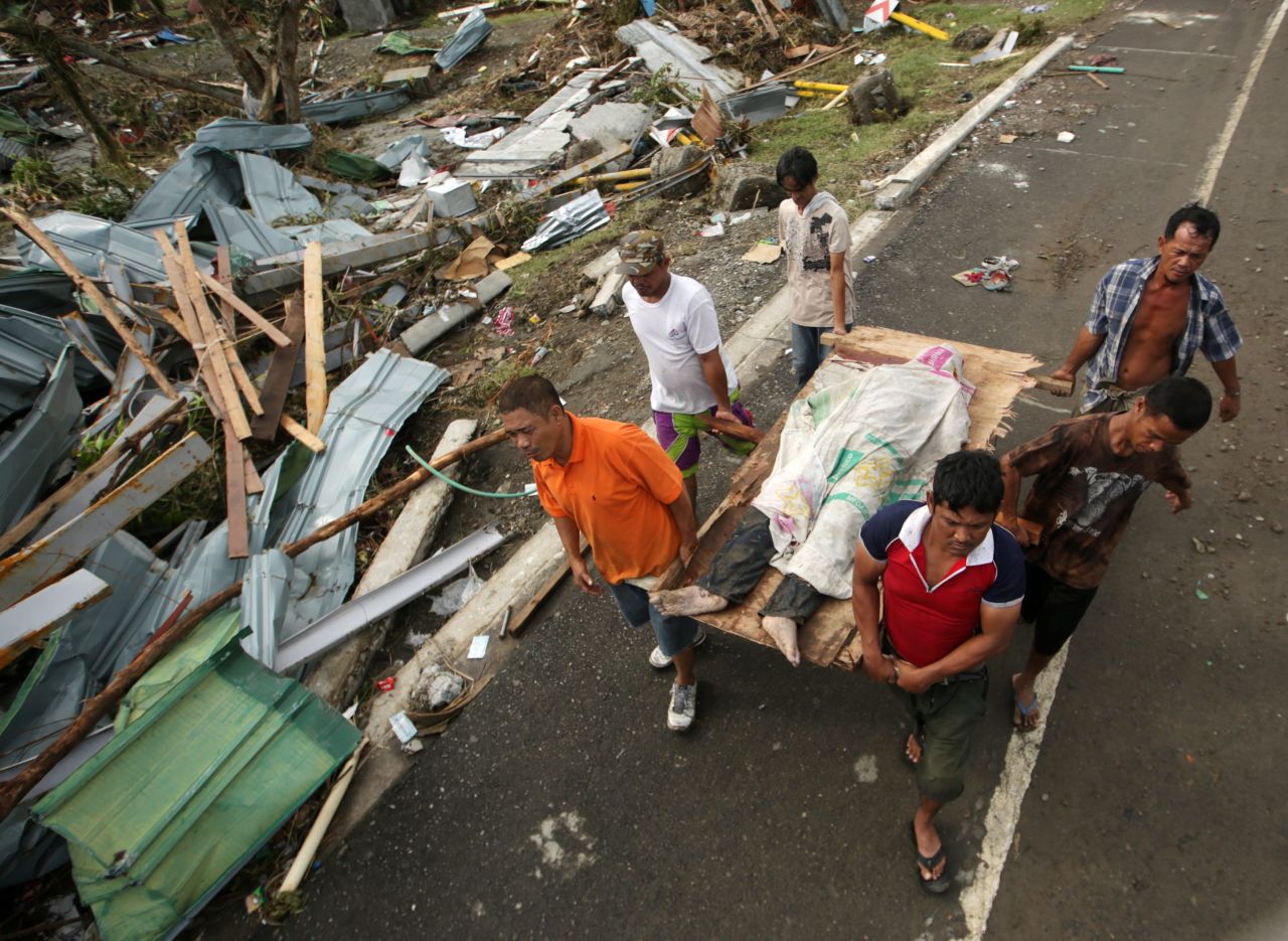 People in Tacloban carry a victim of the typhoon November 9.