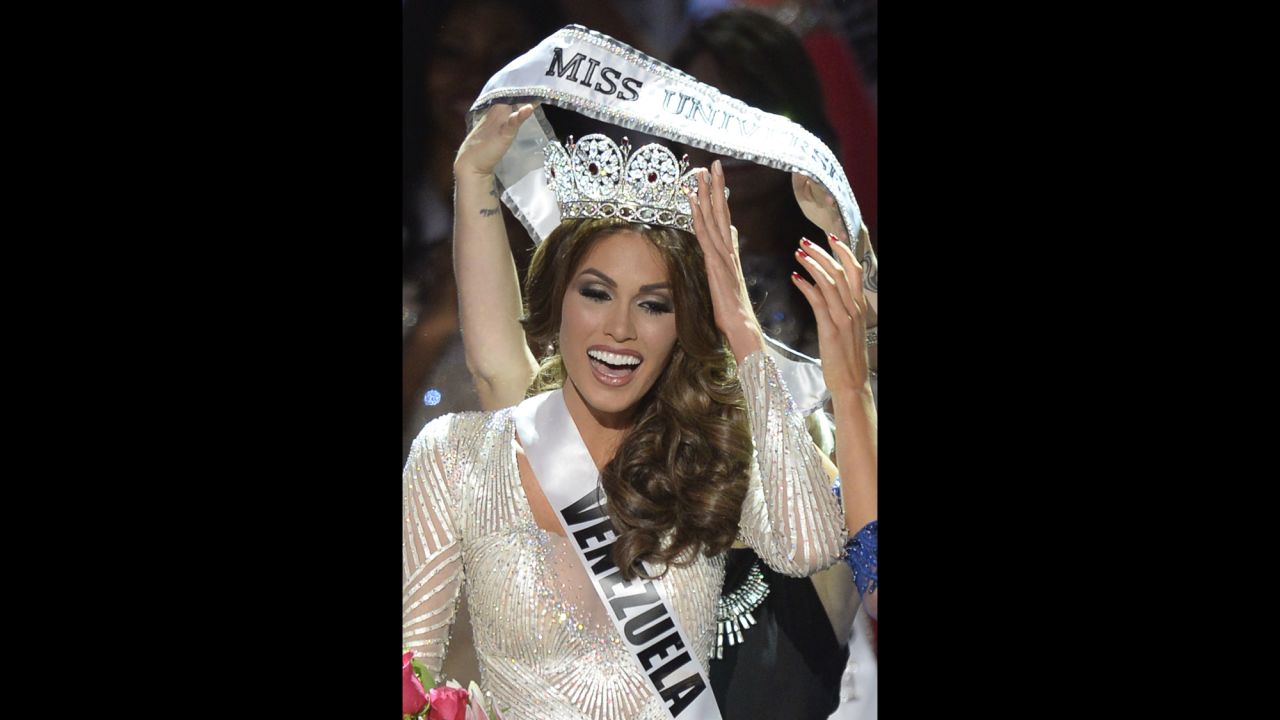 Isler receives the Miss Universe sash.