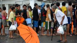 Typhoon victims queue up for relief goods in the aftermath of Super Typhoon Haiyan in Tacloban, eastern island of Leyte on November 9, 2013.