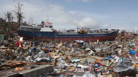 A large boat sits aground, surrounded by debris in Tacloban on November 10.