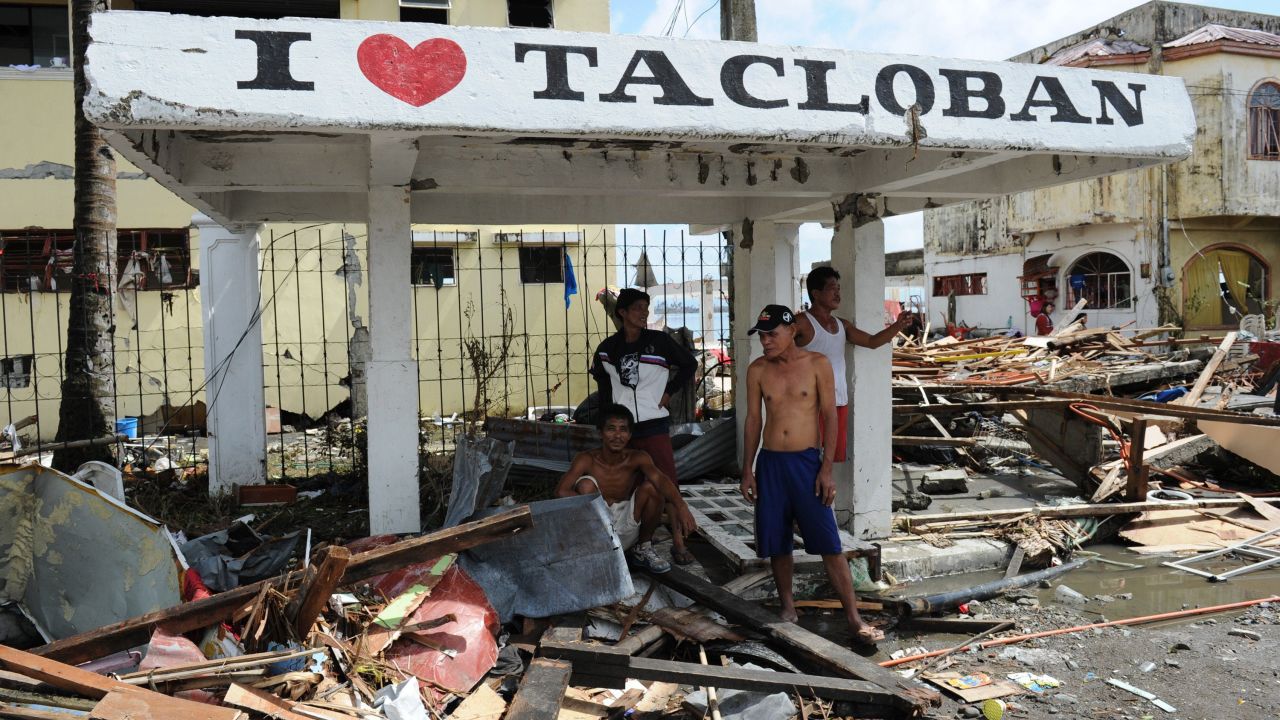 People stand under a shelter in Tacloban.