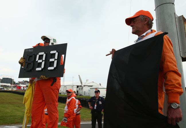 Race marshalls show Marquez the black flag at the Australian GP in October. The Honda rider was disqualified for exceeding the maximum number of laps allowed before a driver must complete a pit stop. Lorenzo took the checkered flag to keep his title chances alive.