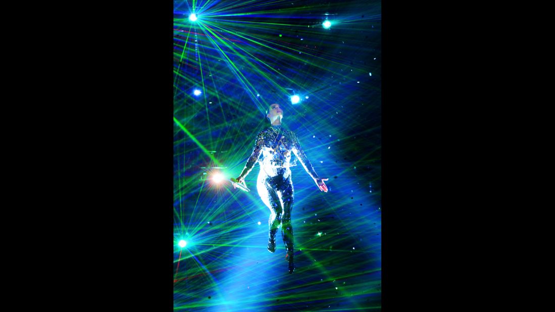 Bathed in blue light, Katy Perry performs.
