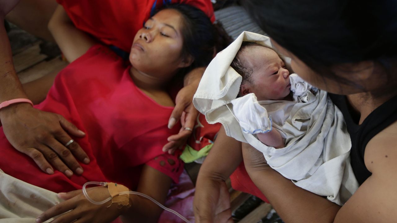 Emily Ortega rests on November 11 after giving birth to Bea Joy at an improvised clinic at the Tacloban airport.