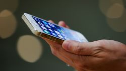 A customer inspects the new iPhone at the Wangfujing flagship store on September 20, 2013 in Beijing, China.