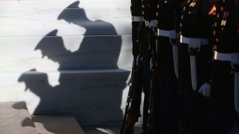 Members of the military stand at attention before Monday's ceremony at the Tomb of the Unknowns.