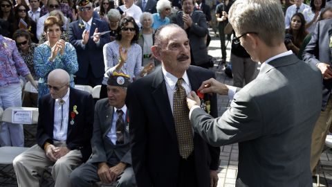 World War II veteran Arthur Nagler is presented with a Legion of Honor medal by Philippe Letrilliart, the consulate general of France in Miami, during a Veterans Day ceremony Monday in Coral Gables, Florida.
