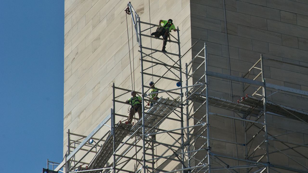 Workers walk on scaffolding around the monument as repairs continue in April 2013.