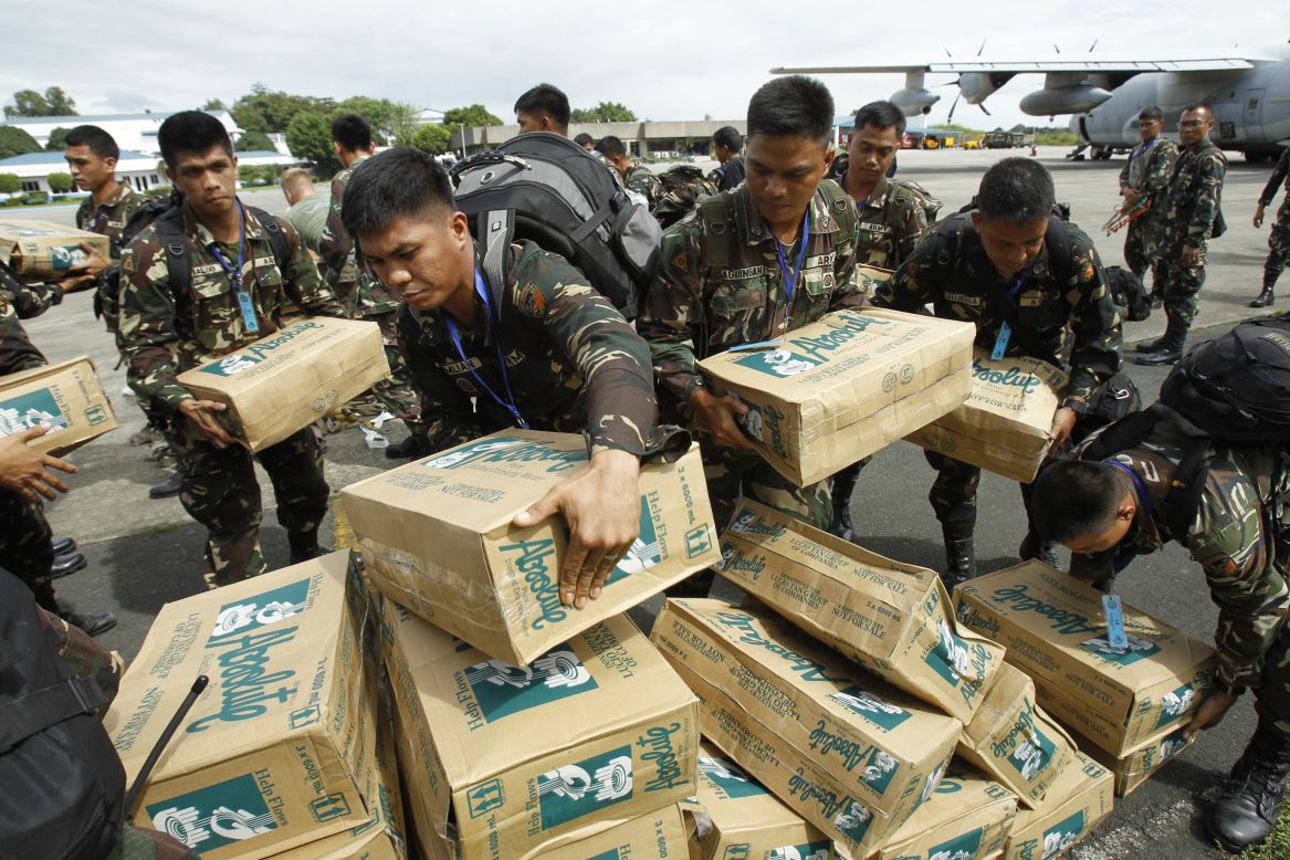 Philippine troops load boxes of water at Villamor Air Force Base in Manila on November 11.