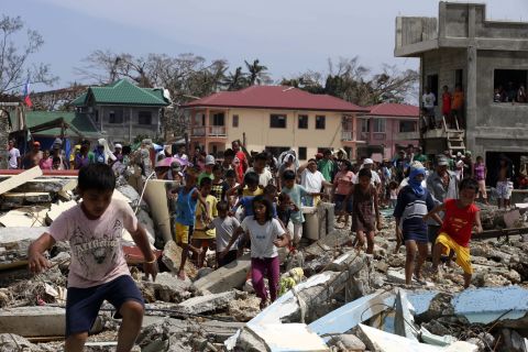 Villagers in Hernani, Philippines, run toward government officials hoping for food November 11.