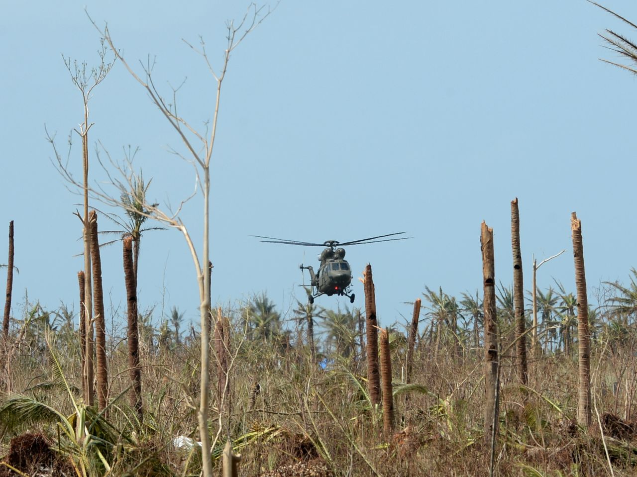 A military helicopter delivering food prepares to land at the airport in Guiuan on November 11.