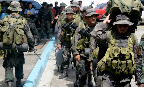 Philippine police commandos prepare to board a military plane in Manila on Sunday, November 10.