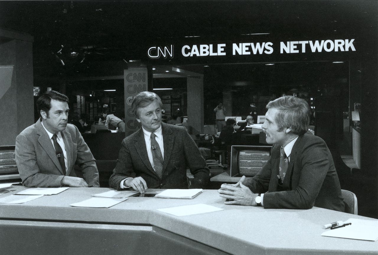 Turner, right, talks on the set of an early CNN broadcast.