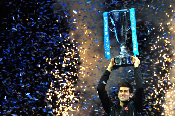 Novak Djokovic lifts the Brad Drewett trophy after beating Rafael Nadal in the final of the ATP World Tour Finals.