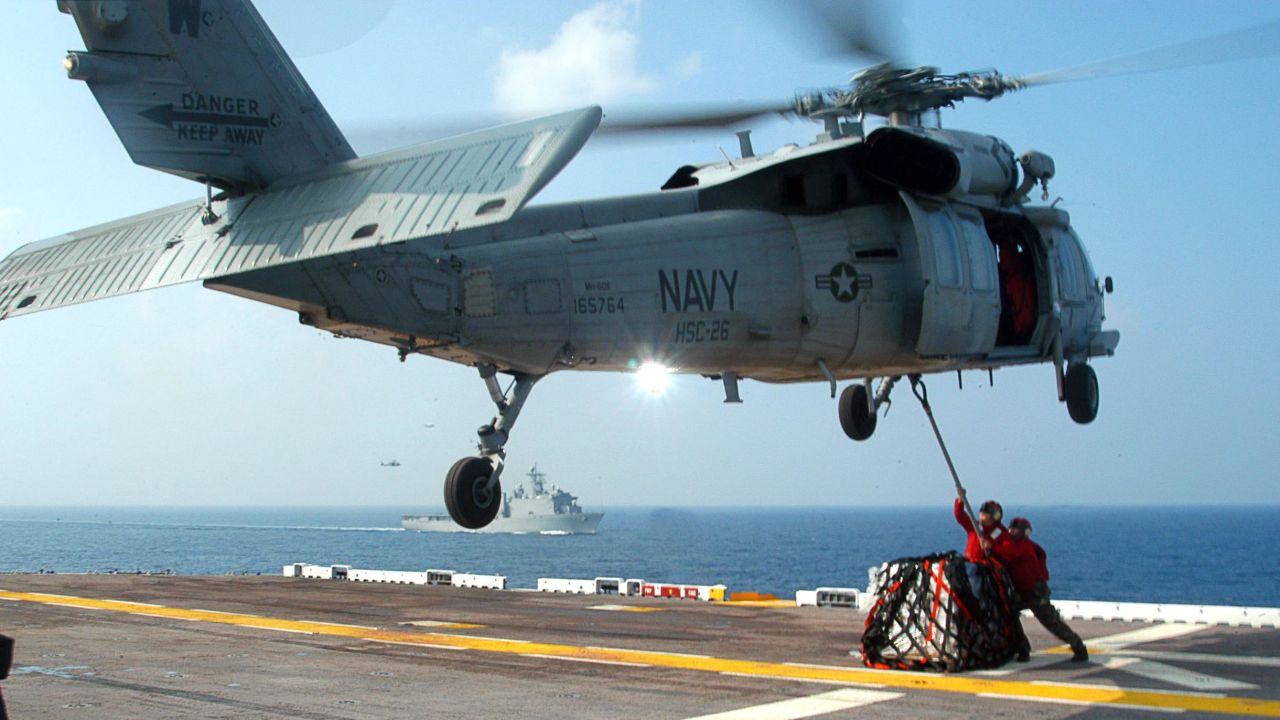 U.S. Navy personnel hook up supplies to a MH-60S Seahawk helicopter in this file photo from September 2005. Seahawk helicopters, which were used to provide relief to Hurricane Katrina victims, will now be brought to the Philippines to help.