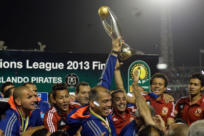 Al Ahly coach Mohamed Youssef holds aloft the African Champions League, a triumph that means the Egyptians will represent the continent at next month's FIFA Club World Cup in Morocco. 