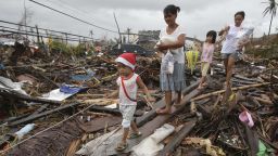 Survivors walk in typhoon ravaged Tacloban city, Leyte province, central Philippines on Tuesday, Nov. 12, 2013.