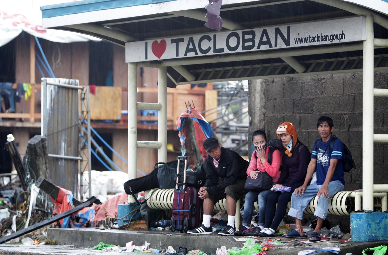 People wait at a bus stop November 12 in Tacloban.