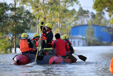Rescuers in Guigang City, China, search a flooded road by boat on November 12. China and Vietnam were also hit hard by the typhoon.