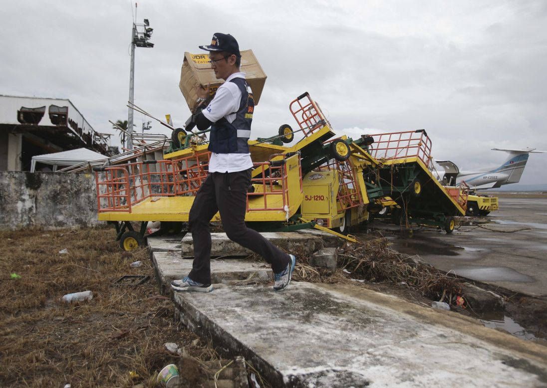 A member of the Japanese Disaster Relief Team carries goods in Tacloban on November 12.