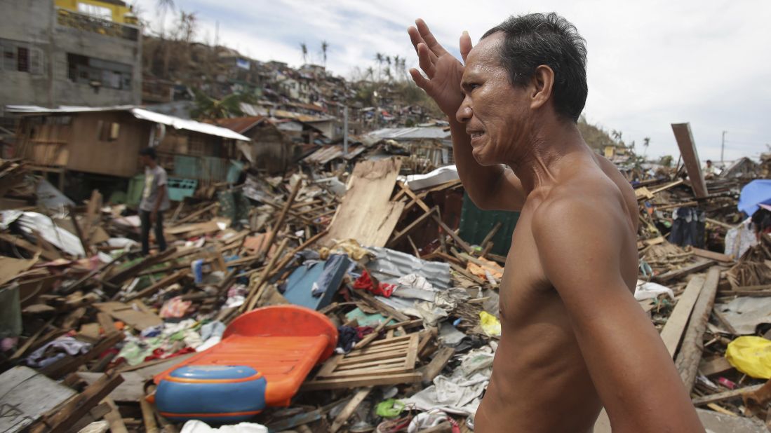 A man looks at his destroyed home November 13 in Tacloban.
