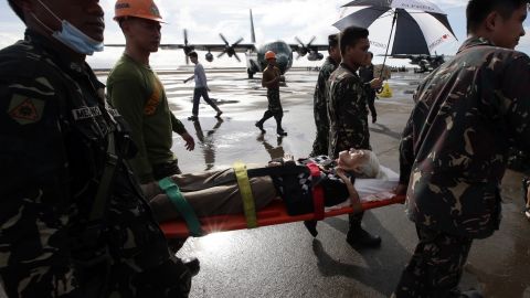 An injured survivor gets carried on a stretcher before being airlifted from Tacloban's airport November 13. 