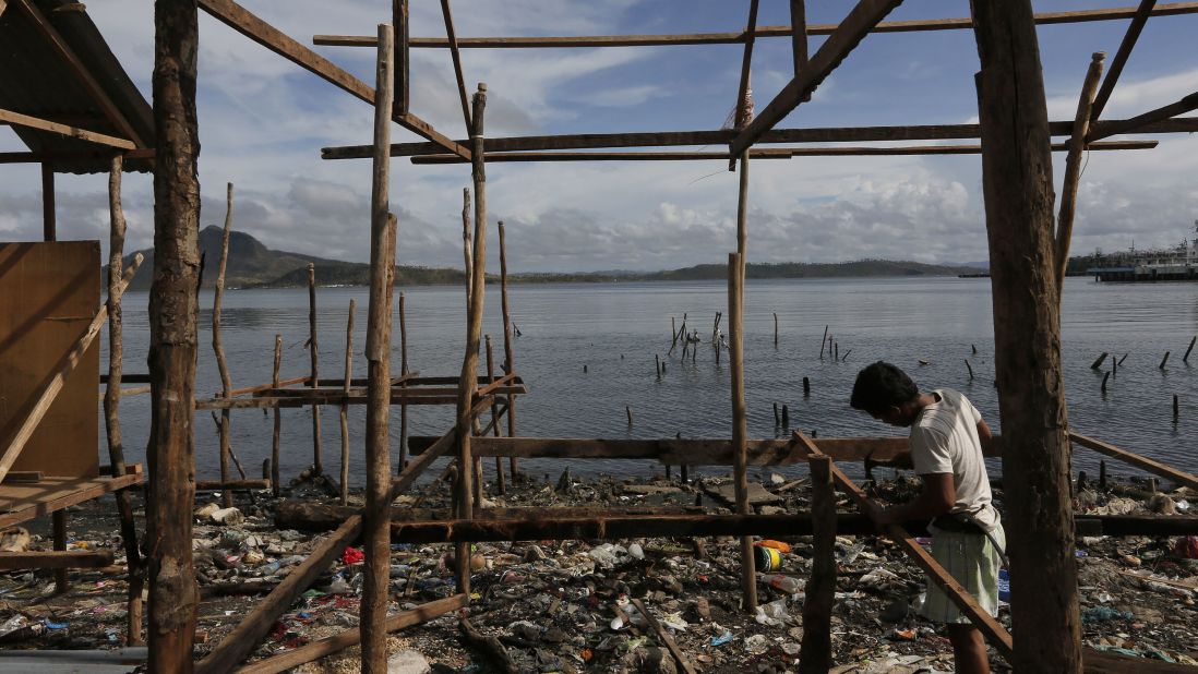 A survivor begins to rebuild his house in Tacloban on November 13.
