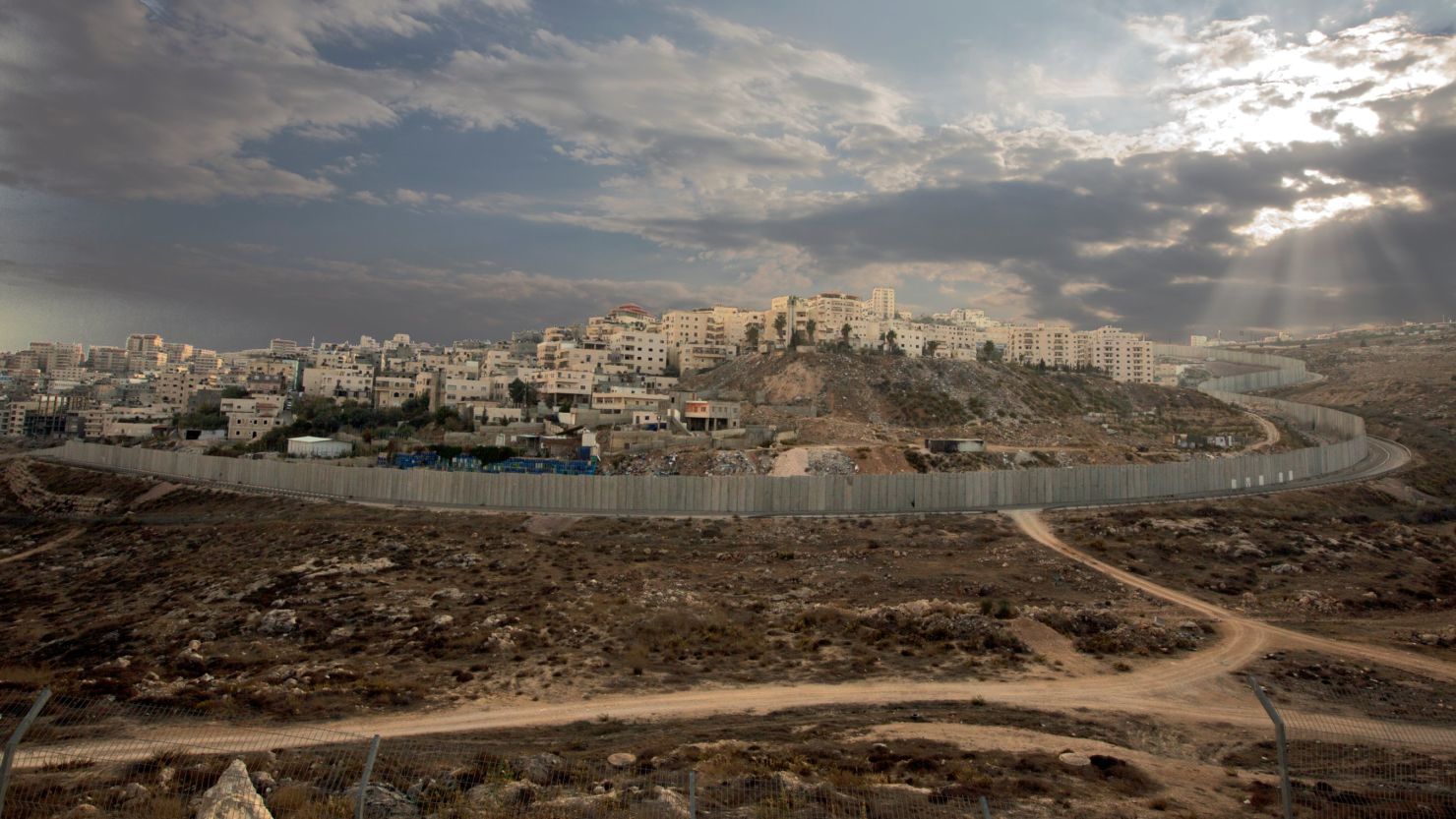 Israel's controversial separation barrier surrounds the Ras Khamis neighbourhood of East Jerusalem, on November 12, 2013. 