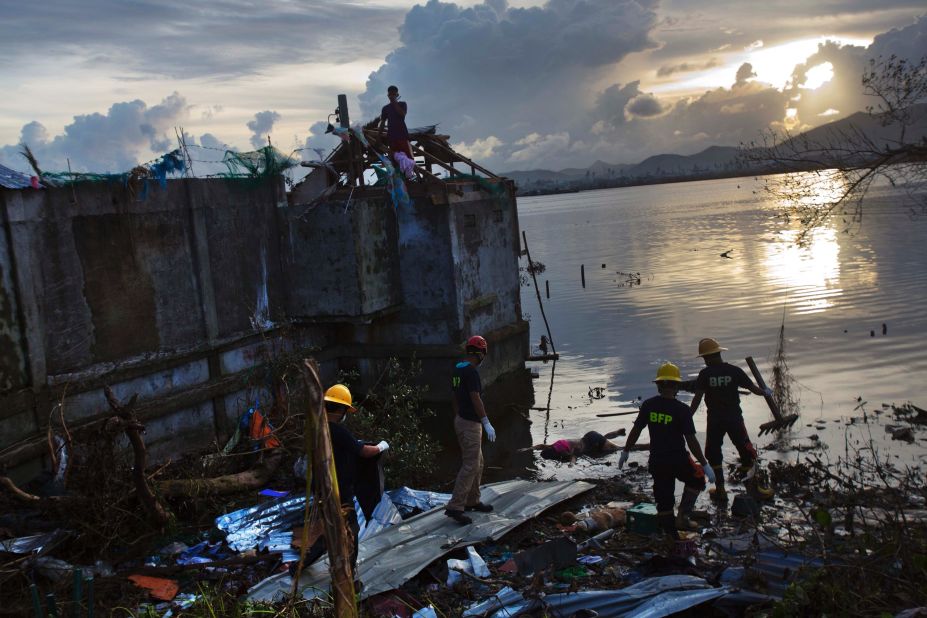 A rescue team wades into Tacloban floodwater to retrieve a body on November 13. 