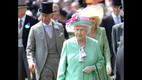 Charles strolls behind his mother in a top hat and umbrella on day two of the Royal Ascot Meeting 2013 horse race in Berkshire.