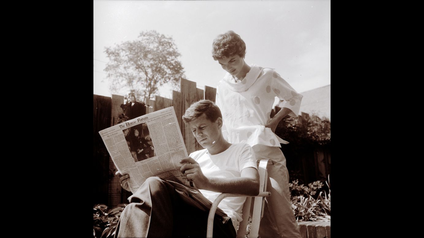 Jackie looking over John's shoulder as he reads the May 7 issue of the Christian Science Monitor on May 9, 1954, Mother's Day.