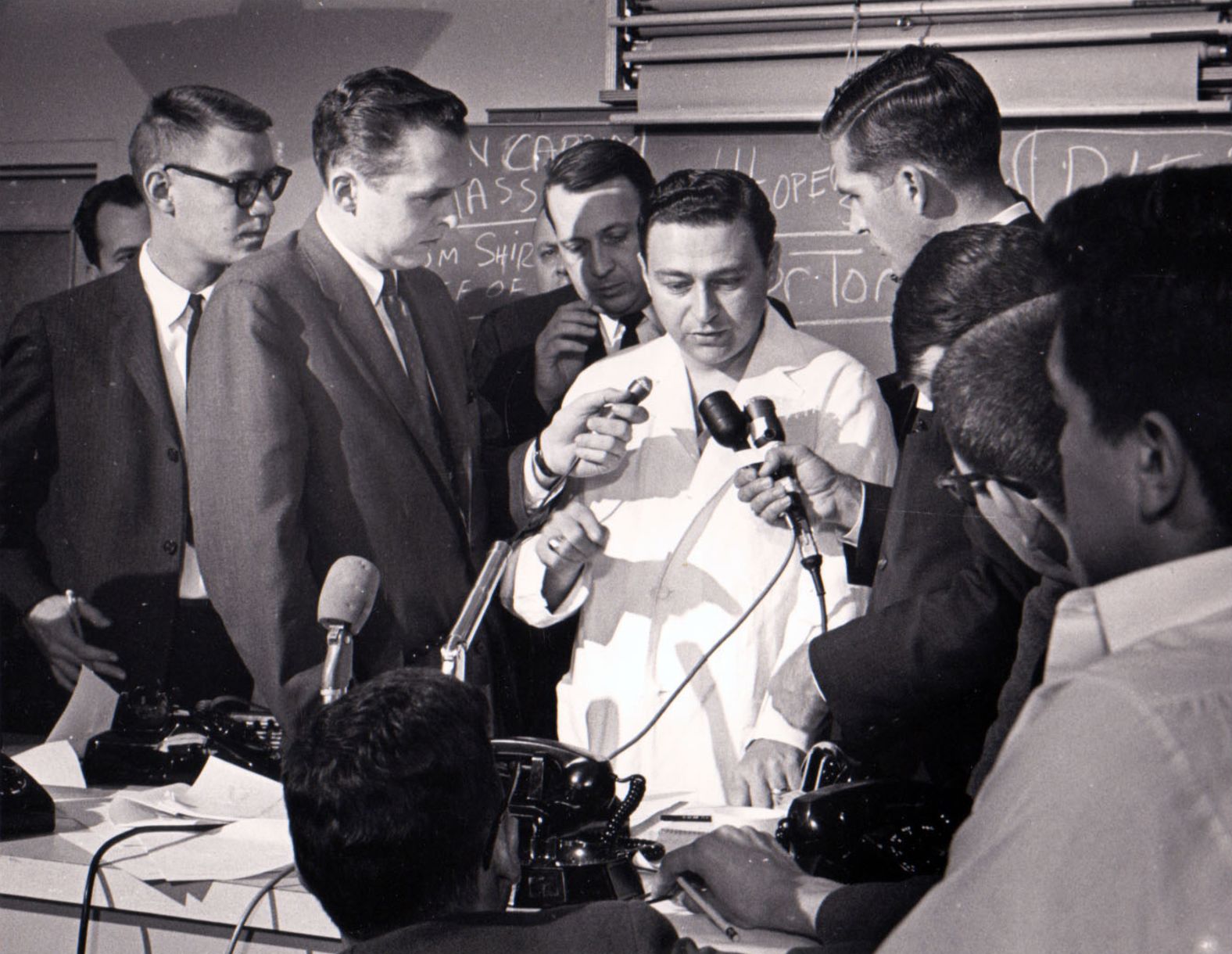 Dr. Tom Shires describes the president's wounds to the press. Four doctors worked on Kennedy inside the emergency room.