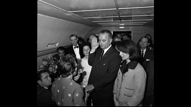 Vice President Lyndon Johnson takes the oath of office to become the 36th president of the United States. He is sworn in by U.S. Federal Judge Sarah T. Hughes, left, with Jacqueline Kennedy by his side on Air Force One.  