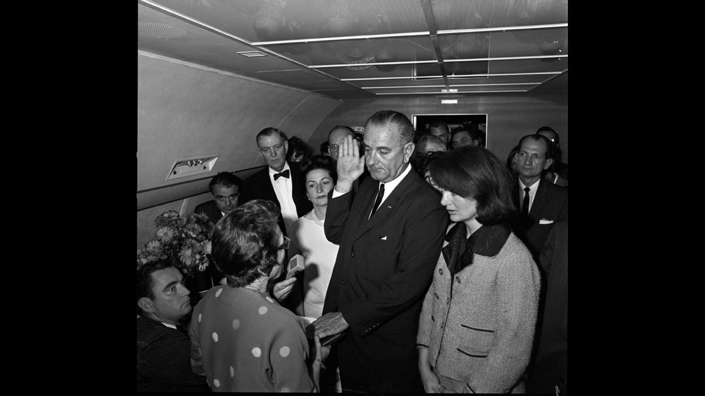 Vice President Lyndon Johnson takes the oath of office to become the 36th president of the United States. He is sworn in by U.S. Federal Judge Sarah T. Hughes, left, with Jacqueline Kennedy by his side on Air Force One.  