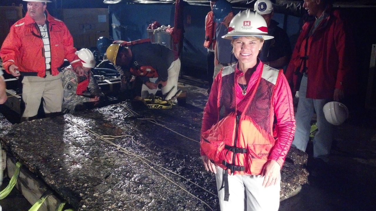 U.S. Army Corps of Engineers archaeologist Julie Morgan next to the 5,000-pound piece of the ironclad.