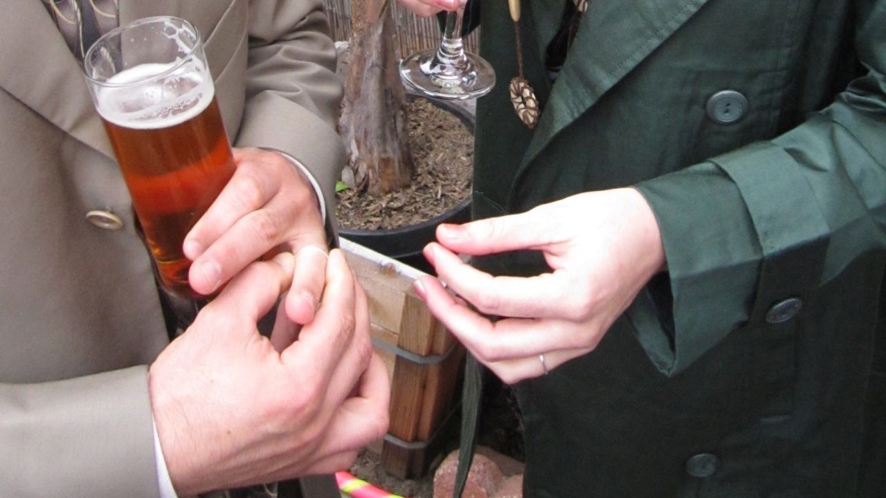Individuals place rings on heir own fingers.