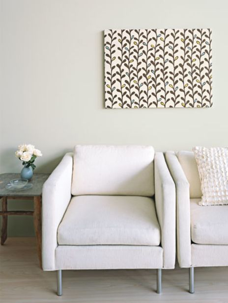Easy DIY upgrade: Frame fabric for quick, inexpensive art. You'll need a staple gun, a stretched canvas (sold in art-supply stores), and some fabric, preferably heavy linen or cotton in a pattern without straight lines. Cut out a piece of the fabric that is four to six inches longer and wider than the frame. Place the material pattern-side down on your work surface, and center the canvas facedown on top of it. Then staple the cloth to the back of the frame