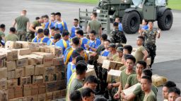 US and Philippine military personnel prepare relief goods for transporting at the military base in Manila on November 12, 2013, before sending the packages to the central coastal city of Tacloban which bore the brunt of Super Typhoon Haiyan when it swept through the central Philippines this weekend.