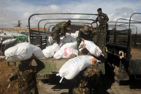 Soldiers load relief goods onto a truck in Tacloban on November 13. 